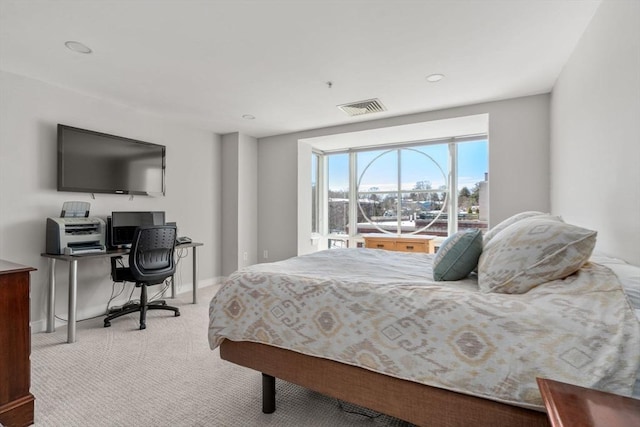 bedroom featuring light carpet, visible vents, and baseboards