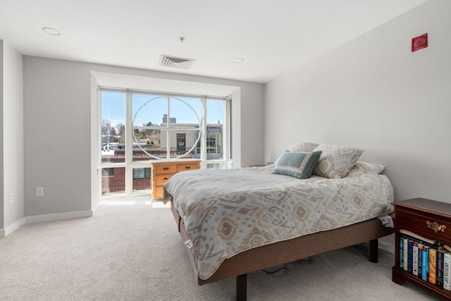 carpeted bedroom featuring visible vents and baseboards