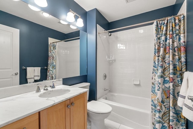 full bathroom featuring tile patterned floors, vanity, toilet, and shower / bath combo with shower curtain