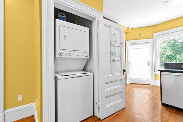 41 Cushing Ave Unit 1, Boston, MA 02125 - laundry room featuring stacked washer / drying machine and wood finished floors