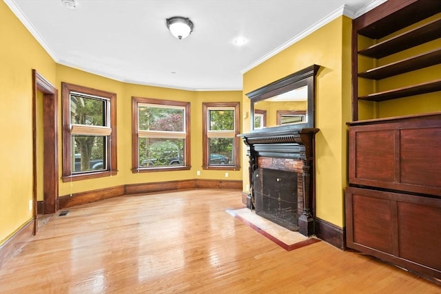 41 Cushing Ave Unit 1, Boston, MA 02125 - unfurnished living room with a fireplace with flush hearth, ornamental molding, and light wood-type flooring