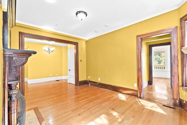 41 Cushing Ave Unit 1, Boston, MA 02125 - unfurnished living room with a chandelier, ornamental molding, and light wood-style flooring