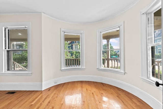 41 Cushing Ave Unit 1, Boston, MA 02125 - empty room featuring plenty of natural light, light wood-type flooring, and crown molding
