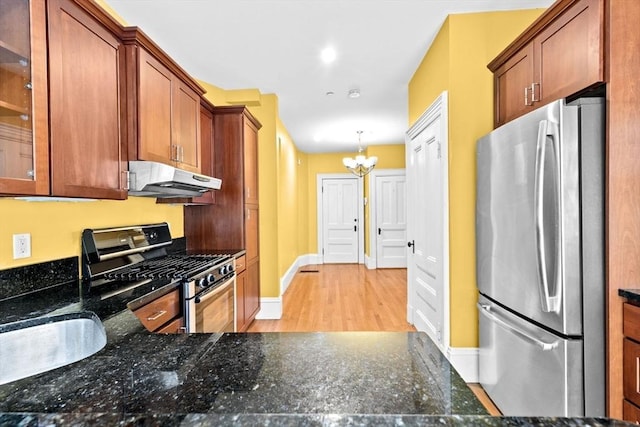 41 Cushing Ave Unit 1, Boston, MA 02125 - kitchen with freestanding refrigerator, range with gas cooktop, under cabinet range hood, a chandelier, and light wood-type flooring