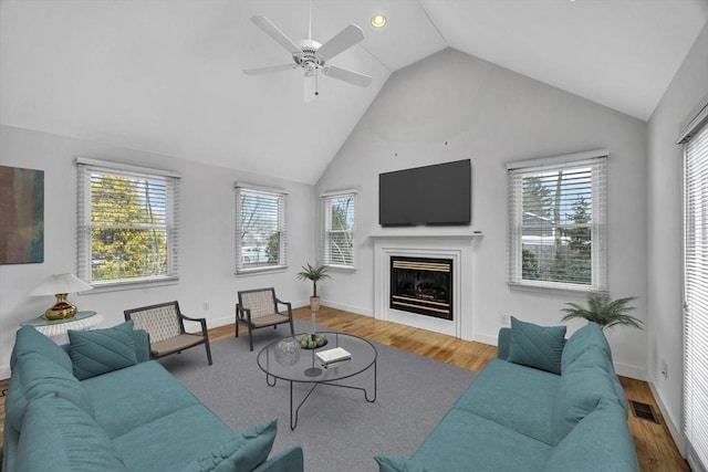 living room with lofted ceiling, ceiling fan, and hardwood / wood-style floors