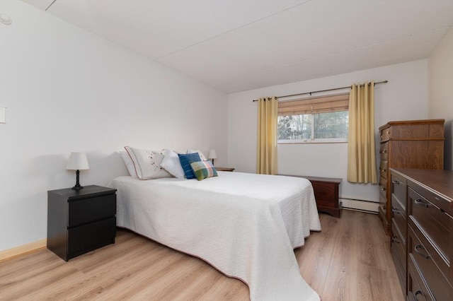 bedroom featuring light hardwood / wood-style floors and a baseboard radiator