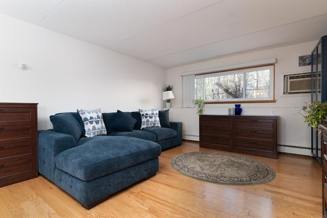 living room with an AC wall unit, light hardwood / wood-style floors, and a baseboard heating unit