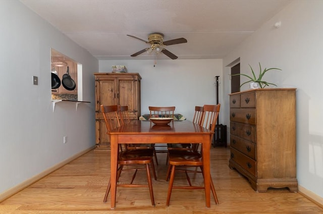 dining area featuring light hardwood / wood-style flooring and ceiling fan