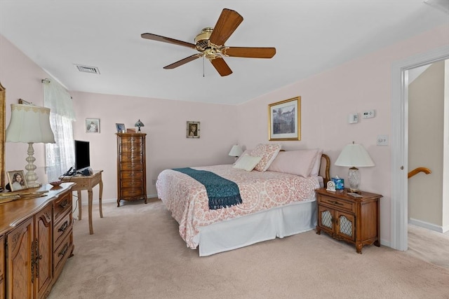 bedroom with baseboards, ceiling fan, light carpet, and visible vents