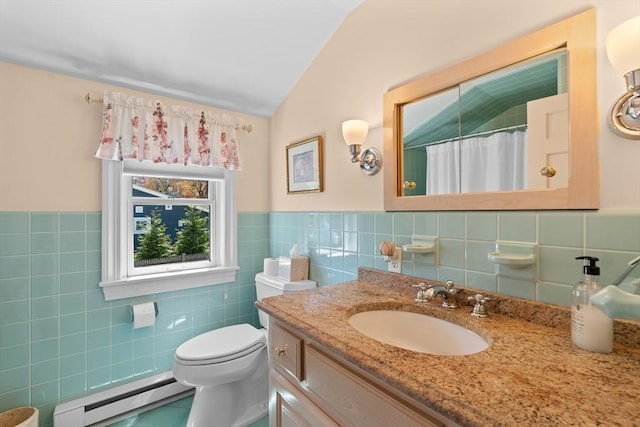 full bath with vanity, toilet, tile walls, baseboard heating, and vaulted ceiling