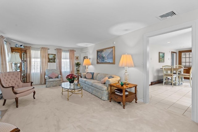 living room featuring light colored carpet and visible vents