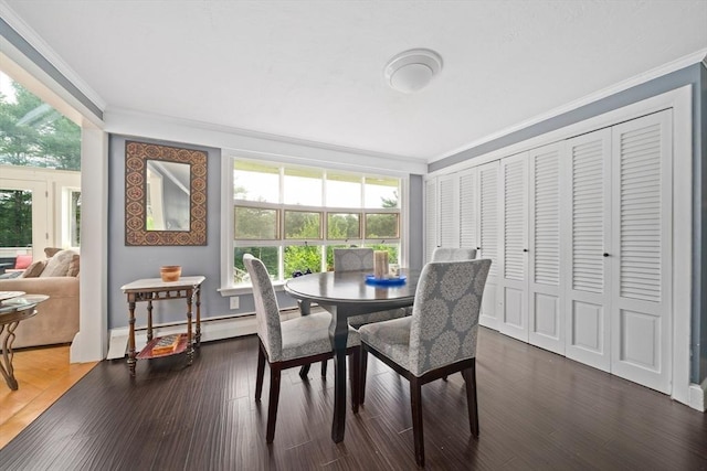 dining space featuring dark wood-type flooring, a baseboard radiator, and ornamental molding