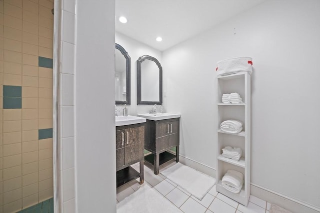 bathroom featuring tile patterned flooring, a shower with shower door, and sink