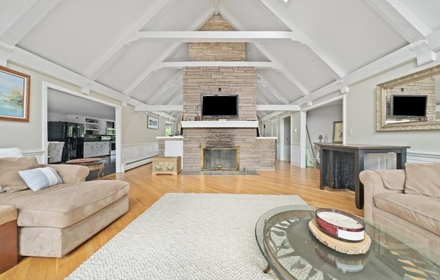 living room with a fireplace, hardwood / wood-style flooring, baseboard heating, and lofted ceiling