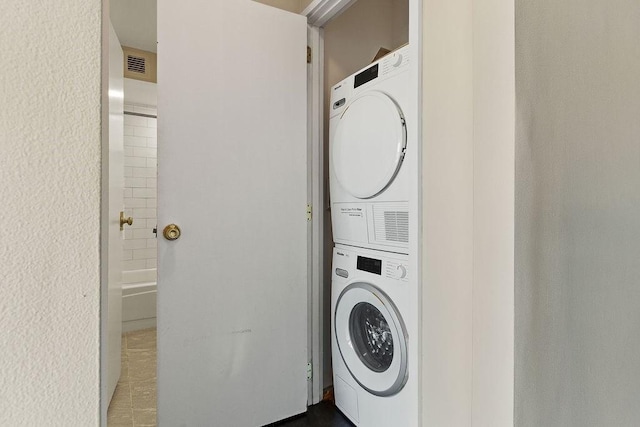 washroom with stacked washer and dryer