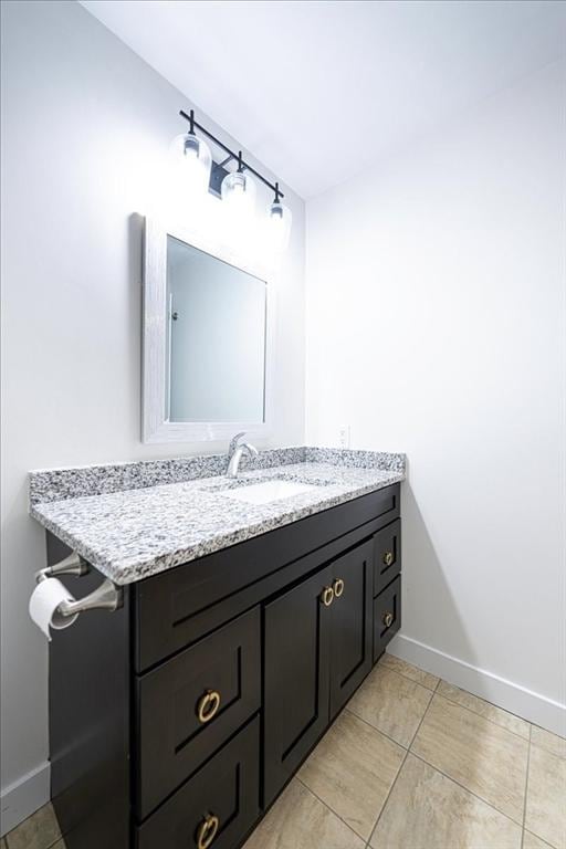 bathroom with vanity and baseboards