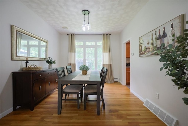 32 Lowe Meadow Ln, North Attleboro, MA 02760 - dining area featuring light wood finished floors, baseboards, and a textured ceiling