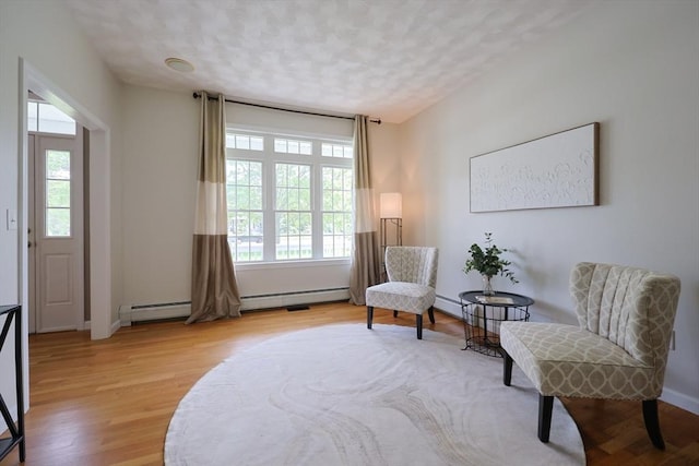 32 Lowe Meadow Ln, North Attleboro, MA 02760 - living area with plenty of natural light, light wood-style flooring, baseboard heating, a textured ceiling, and baseboards
