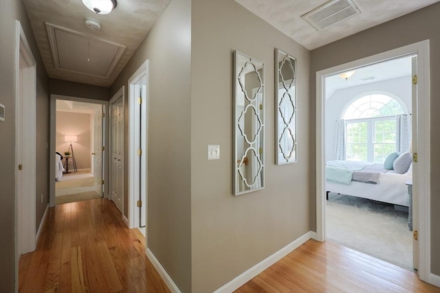 32 Lowe Meadow Ln, North Attleboro, MA 02760 - hall with attic access, light wood-type flooring, and baseboards