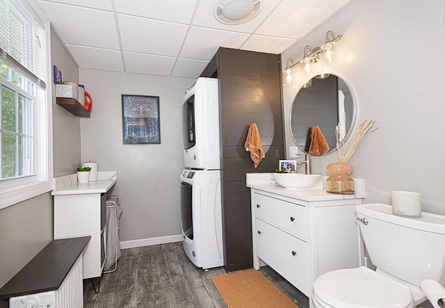 3 Worcester, Clinton, MA 01510 - bathroom featuring stacked washer / dryer, a paneled ceiling, vanity, wood finished floors, and healthy amount of natural light