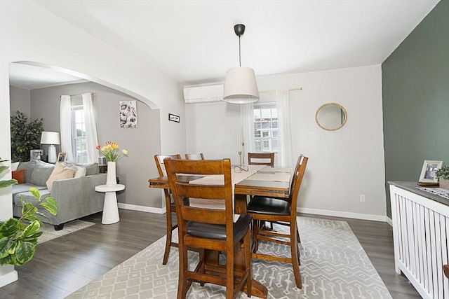 3 Worcester, Clinton, MA 01510 - dining room with arched walkways, a wall mounted air conditioner, dark wood finished floors, and baseboards