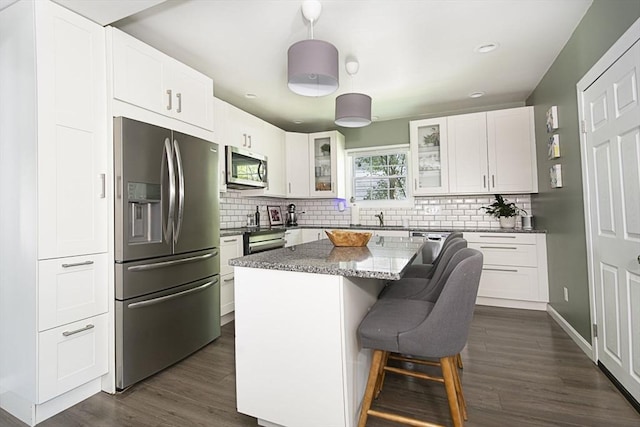 3 Worcester, Clinton, MA 01510 - kitchen featuring stainless steel appliances, glass insert cabinets, dark wood-style flooring, a kitchen bar, and backsplash