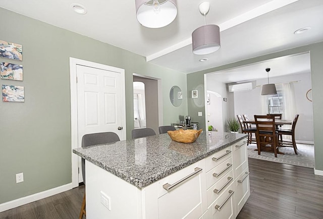 3 Worcester, Clinton, MA 01510 - kitchen featuring white cabinetry, dark wood finished floors, a wall mounted air conditioner, hanging light fixtures, and dark stone counters