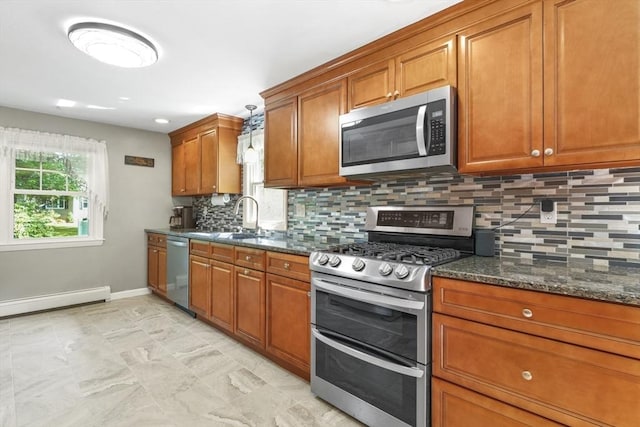 167 Montaup Ave, Dracut, MA 01826 - kitchen featuring stainless steel appliances, baseboards, brown cabinetry, a baseboard heating unit, and tasteful backsplash