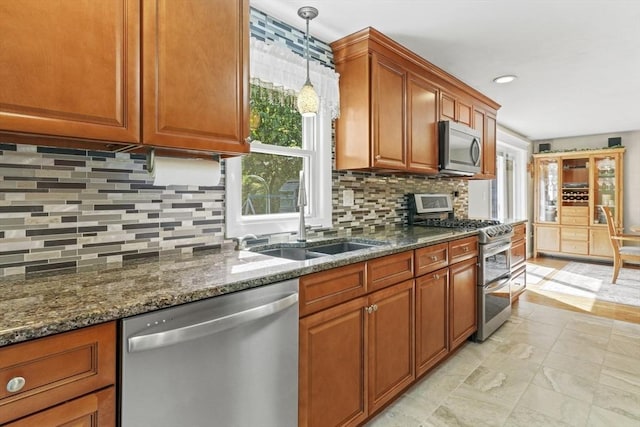 167 Montaup Ave, Dracut, MA 01826 - kitchen with stainless steel appliances, a sink, brown cabinetry, decorative backsplash, and recessed lighting