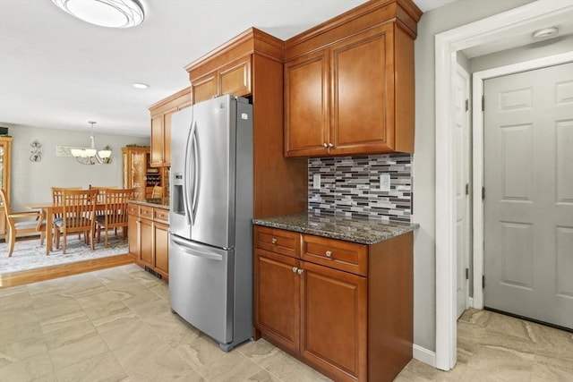 167 Montaup Ave, Dracut, MA 01826 - kitchen featuring stainless steel fridge, brown cabinetry, a chandelier, and backsplash