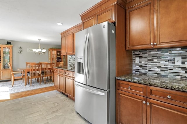 167 Montaup Ave, Dracut, MA 01826 - kitchen featuring stainless steel fridge, brown cabinetry, a chandelier, backsplash, and recessed lighting