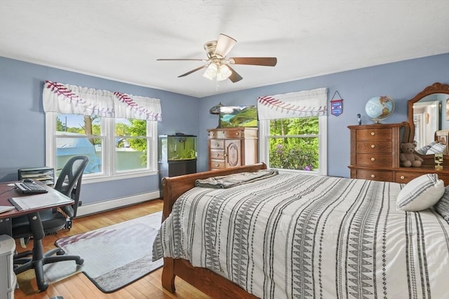 167 Montaup Ave, Dracut, MA 01826 - bedroom featuring multiple windows, wood finished floors, a desk, and a baseboard heating unit
