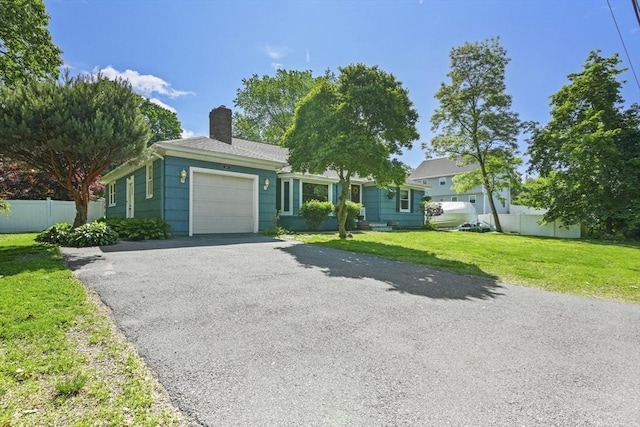 167 Montaup Ave, Dracut, MA 01826 - ranch-style house with an attached garage, a chimney, and asphalt driveway