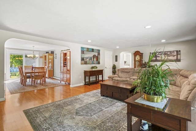 167 Montaup Ave, Dracut, MA 01826 - living area featuring arched walkways, a chandelier, wood finished floors, recessed lighting, and baseboards