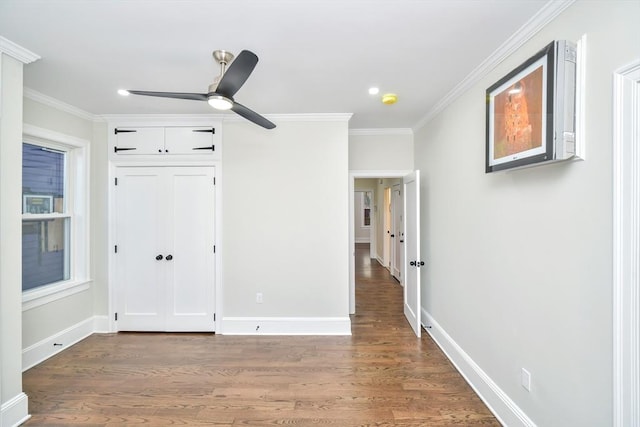 unfurnished bedroom featuring ceiling fan, dark hardwood / wood-style flooring, and crown molding