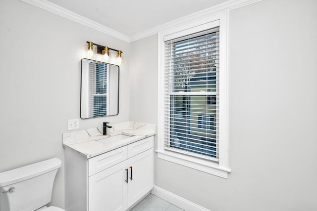 bathroom featuring vanity, toilet, and ornamental molding