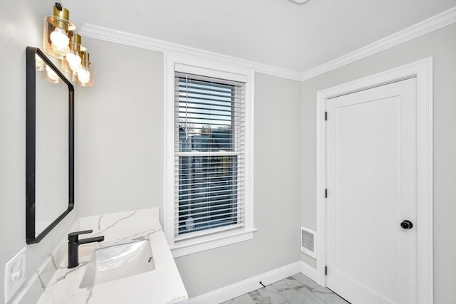 foyer featuring ornamental molding and sink