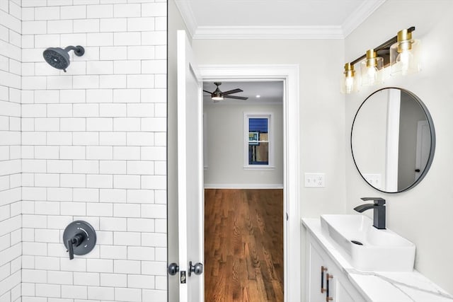 bathroom featuring hardwood / wood-style floors, ornamental molding, and tiled shower