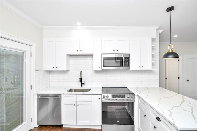 kitchen with pendant lighting, white cabinetry, sink, and appliances with stainless steel finishes