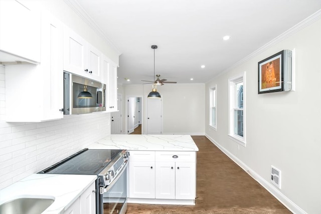 kitchen featuring white cabinets, light stone countertops, appliances with stainless steel finishes, and tasteful backsplash