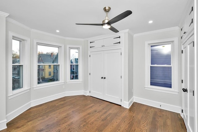 unfurnished bedroom featuring dark hardwood / wood-style flooring, a closet, ceiling fan, and crown molding