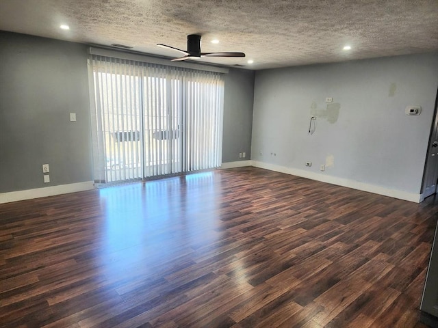 spare room with visible vents, baseboards, dark wood finished floors, a textured ceiling, and a ceiling fan