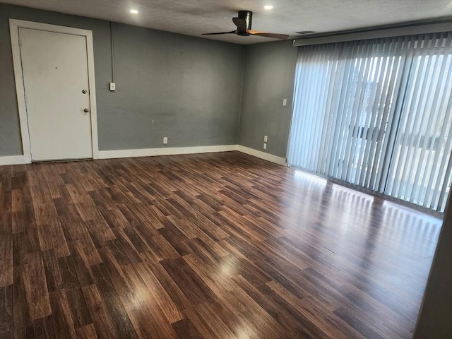 unfurnished living room with ceiling fan, visible vents, baseboards, and wood finished floors