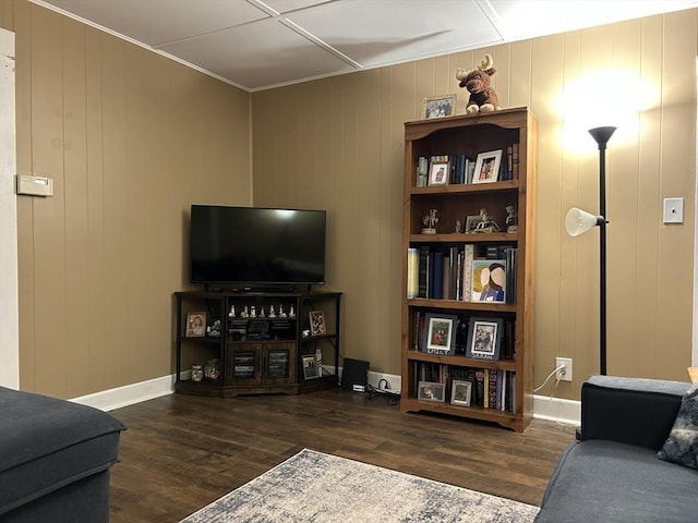 living area featuring baseboards and wood finished floors