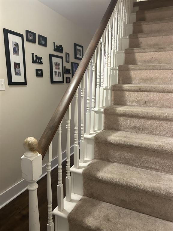 stairs featuring baseboards and wood finished floors