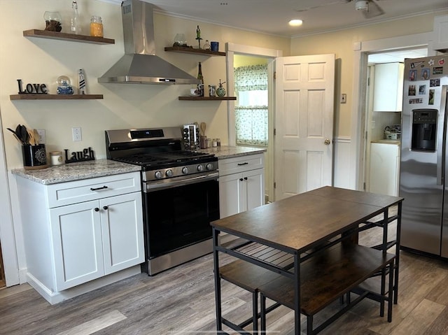 kitchen with wall chimney exhaust hood, appliances with stainless steel finishes, open shelves, and white cabinetry