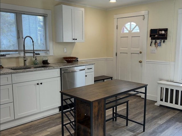 kitchen with dark wood-style flooring, white cabinetry, a sink, and stainless steel dishwasher