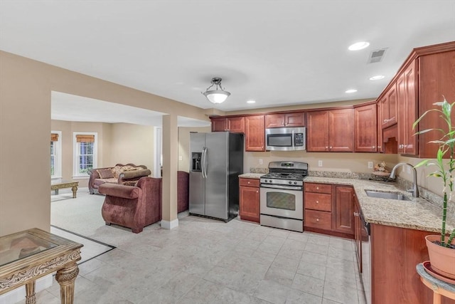 52 Sylvan Dr, Stow, MA 01775 - kitchen with appliances with stainless steel finishes, light stone counters, open floor plan, and recessed lighting