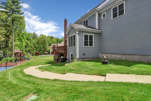 52 Sylvan Dr, Stow, MA 01775 - view of home's exterior with a chimney, a yard, a playground, and a wooden deck