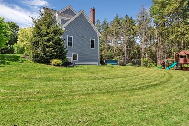 52 Sylvan Dr, Stow, MA 01775 - view of side of home with a playground, a chimney, and a yard
